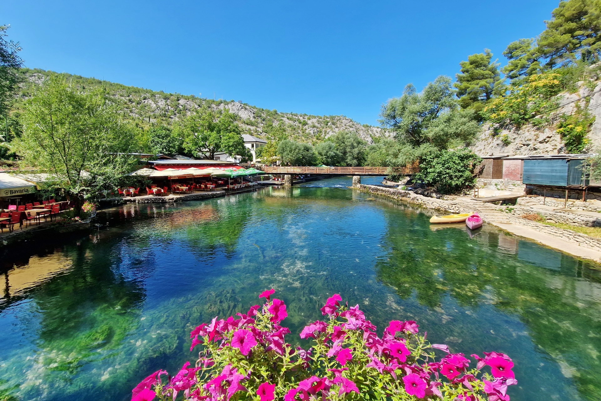 Buna River in Blagaj with flowers and restaurants