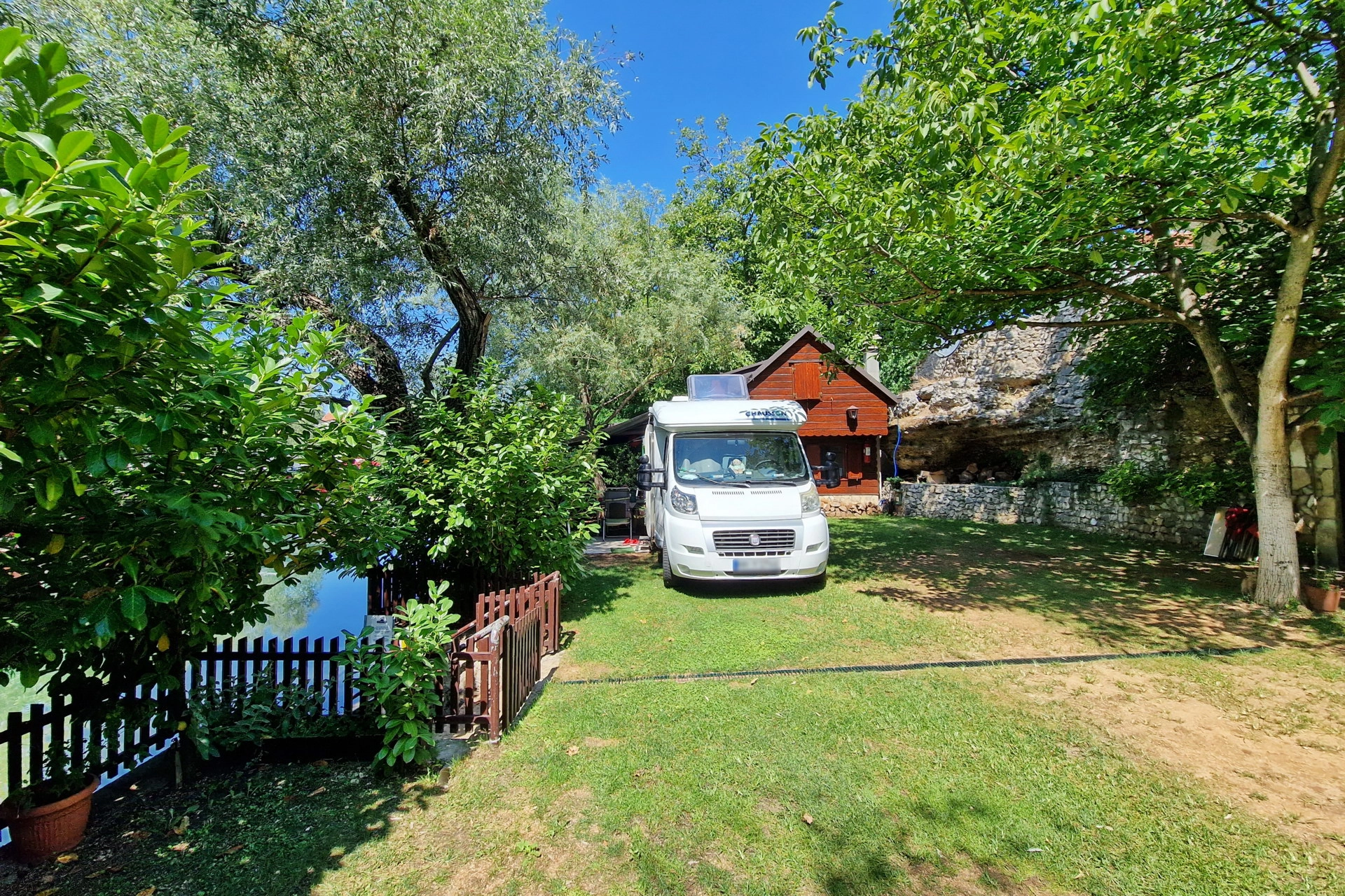 Camper van parked in green camp